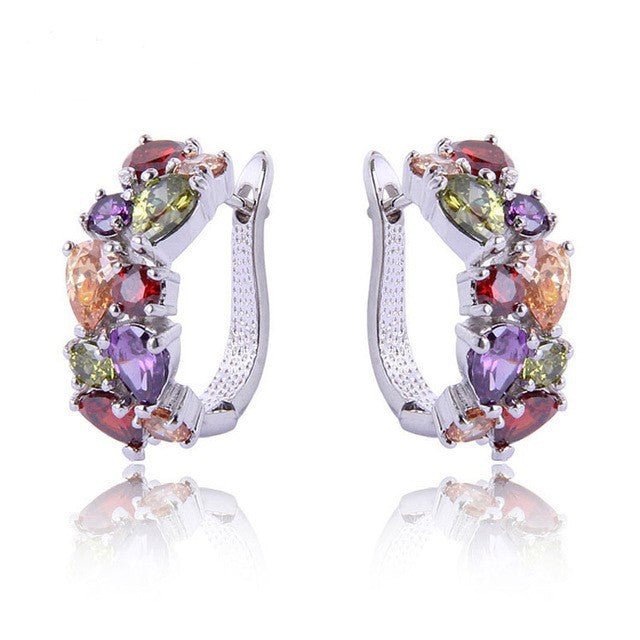 Ear climber styled alongside huggie hoop for layered ear look