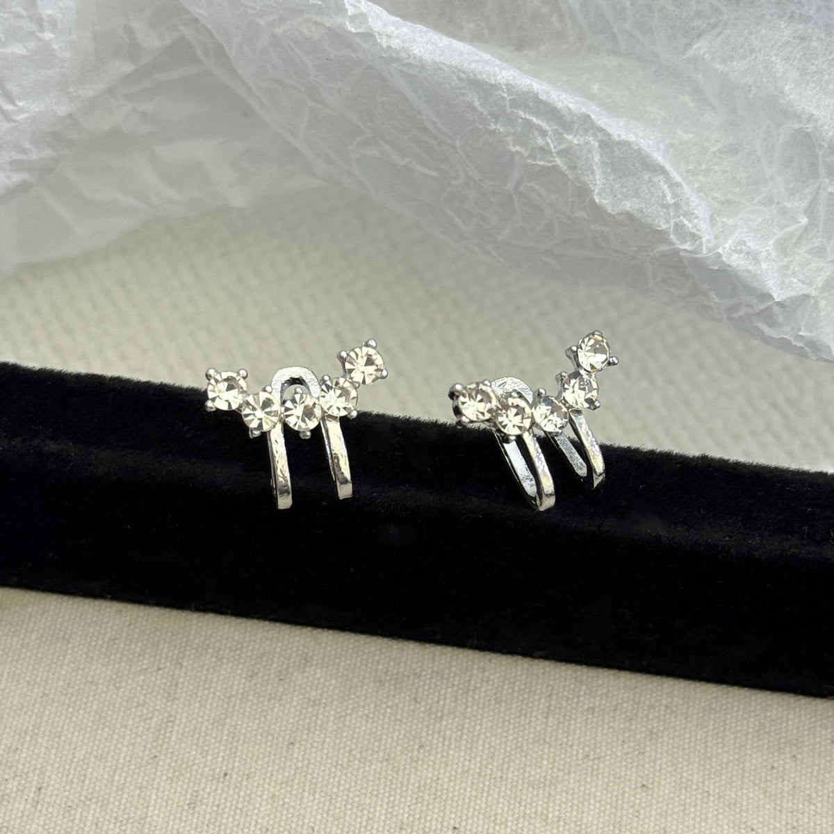 Crystal ear climber catching light — sparkle detail close-up