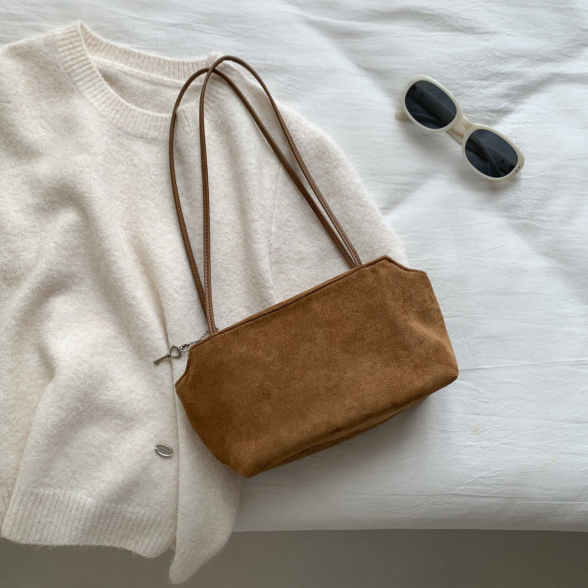 Hand-carry view of featherlight suede petite shoulder bag