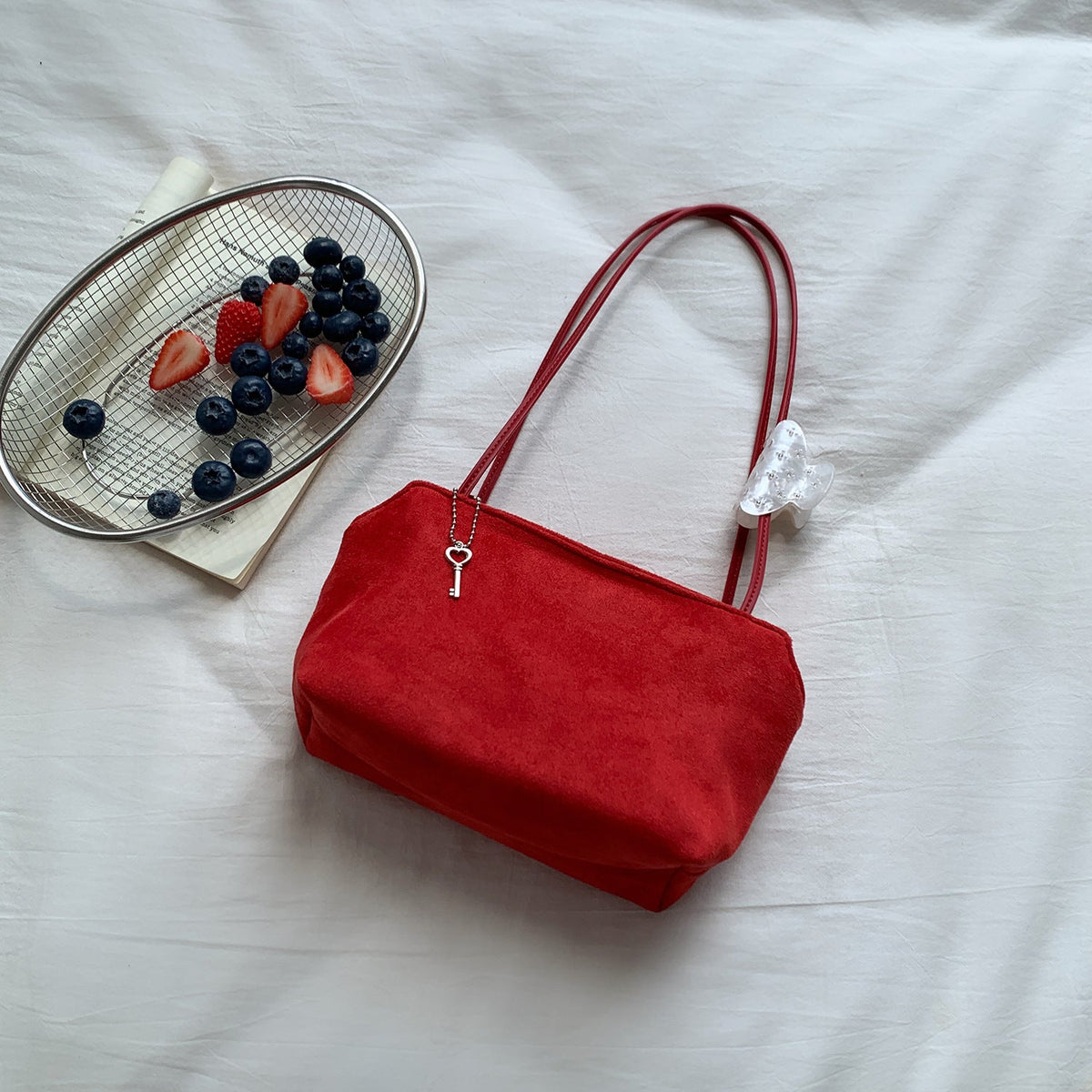 Side view of suede-feel petite shoulder bag showing width and depth