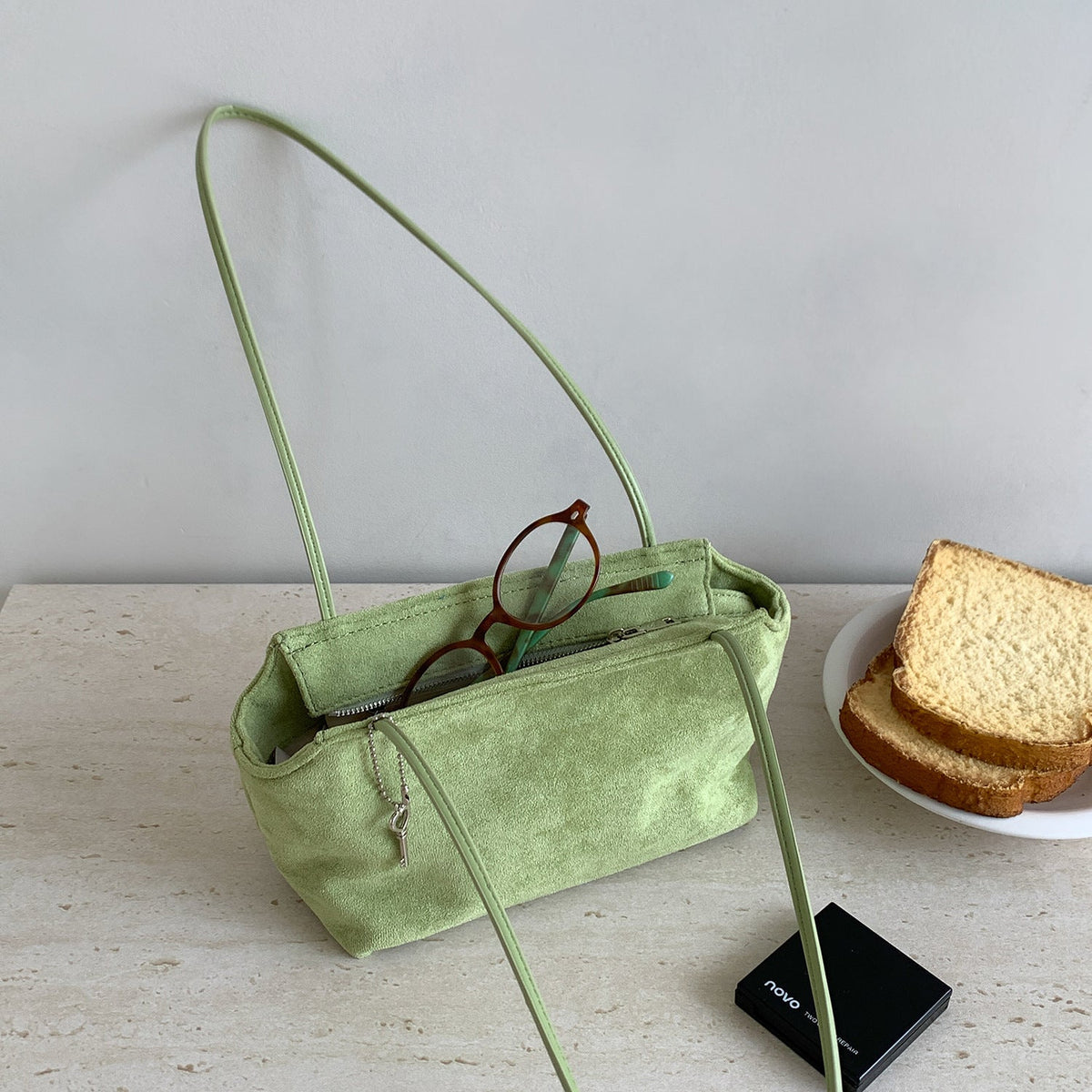 Flat lay of suede-feel underarm bag showing dimensions and strap