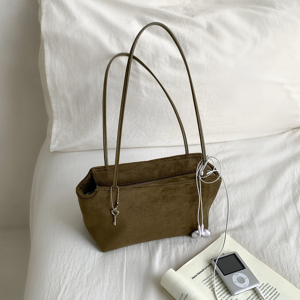 Styled overhead shot of vintage suede texture purse on neutral background