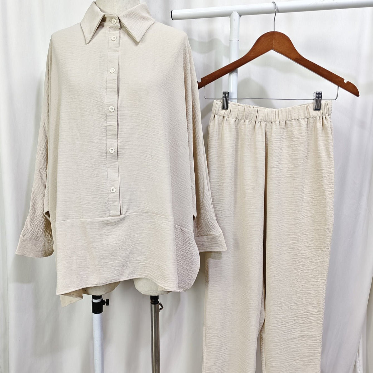 Flat lay of both pieces — batwing shirt and straight-leg trousers — from the co-ord set