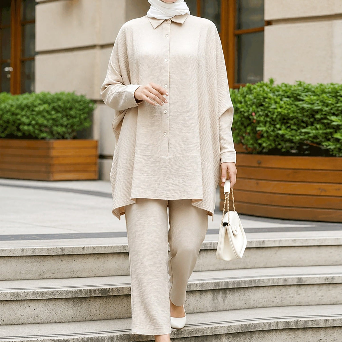 Back view showing asymmetric curved hem and longer back panel of the batwing co-ord shirt