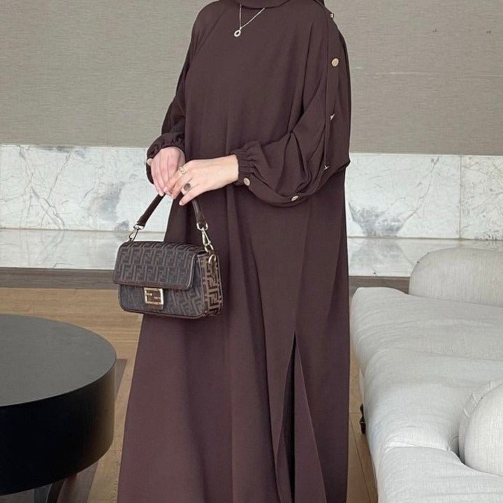 Side view showing deep side slits and relaxed straight silhouette of crinkle maxi abaya