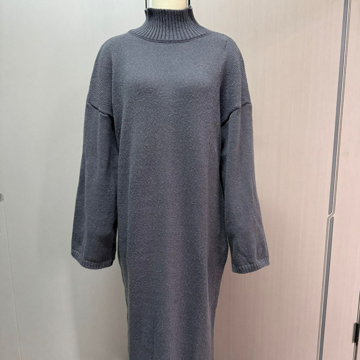 Close-up of soft knitted fabric texture on full-length modest maxi dress
