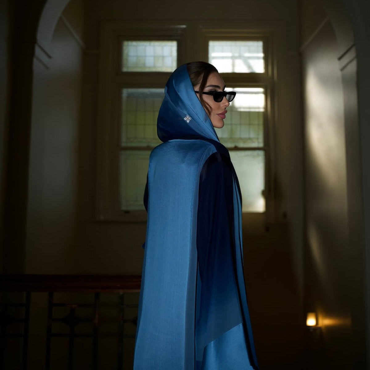 Full-length navy open abaya styled with matching sky blue hijab