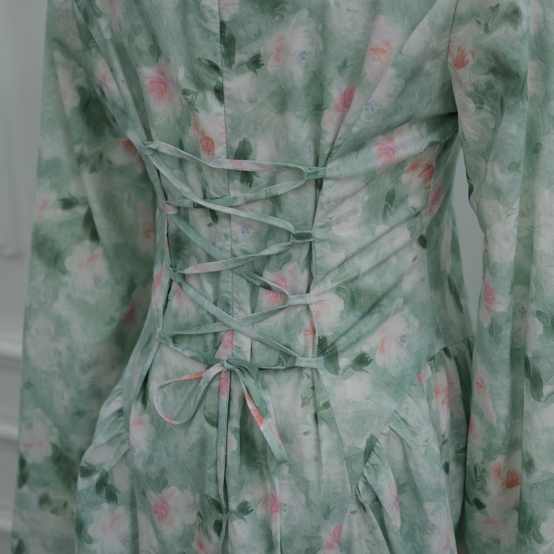 Mint green colourway back view of watercolour floral bell sleeve dress