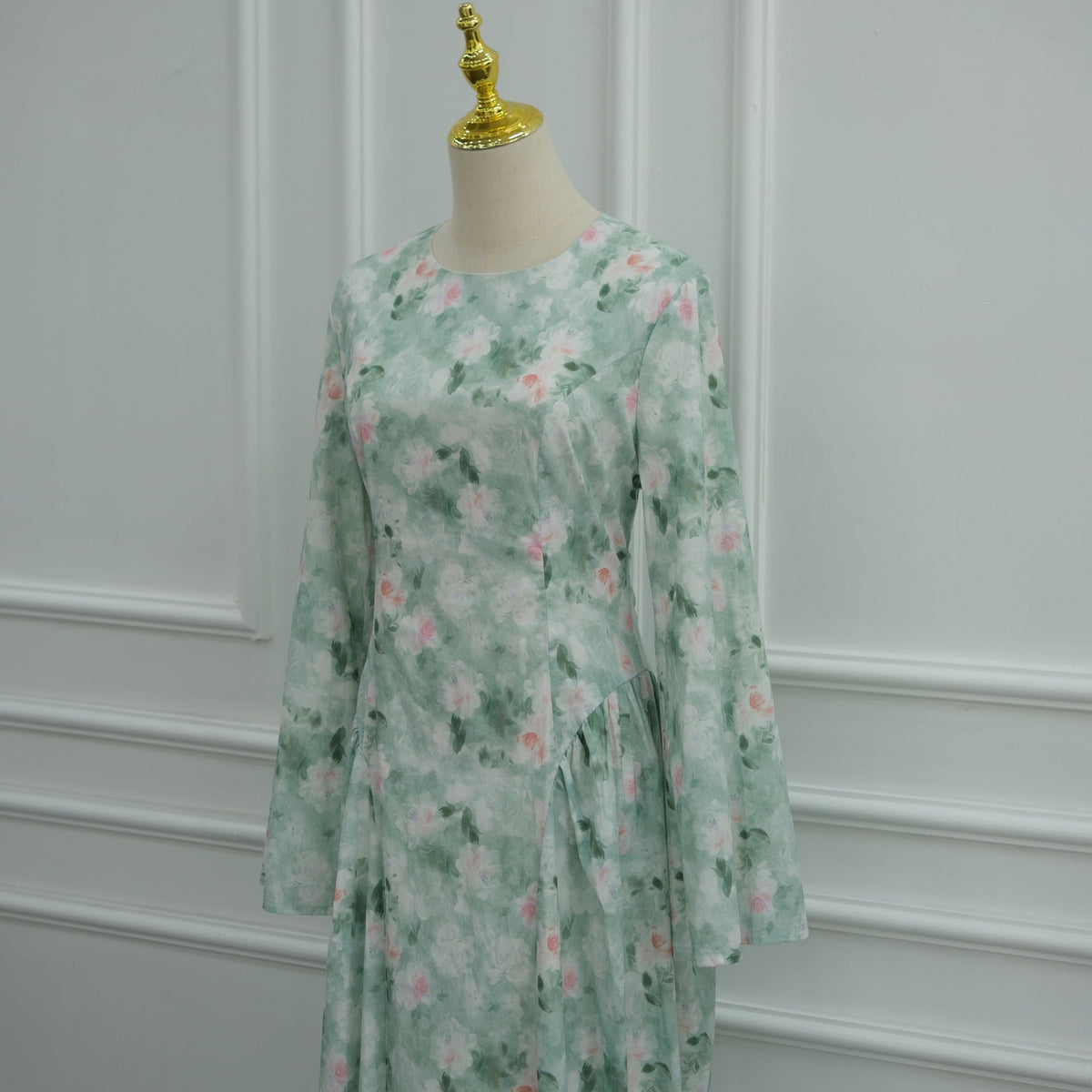 Three-quarter view of fitted bodice and bell sleeve on floral modest dress