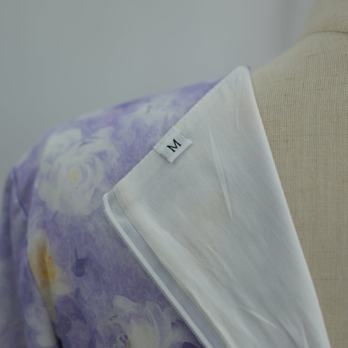 Side view of A-line skirt and flared sleeves on watercolour floral dress