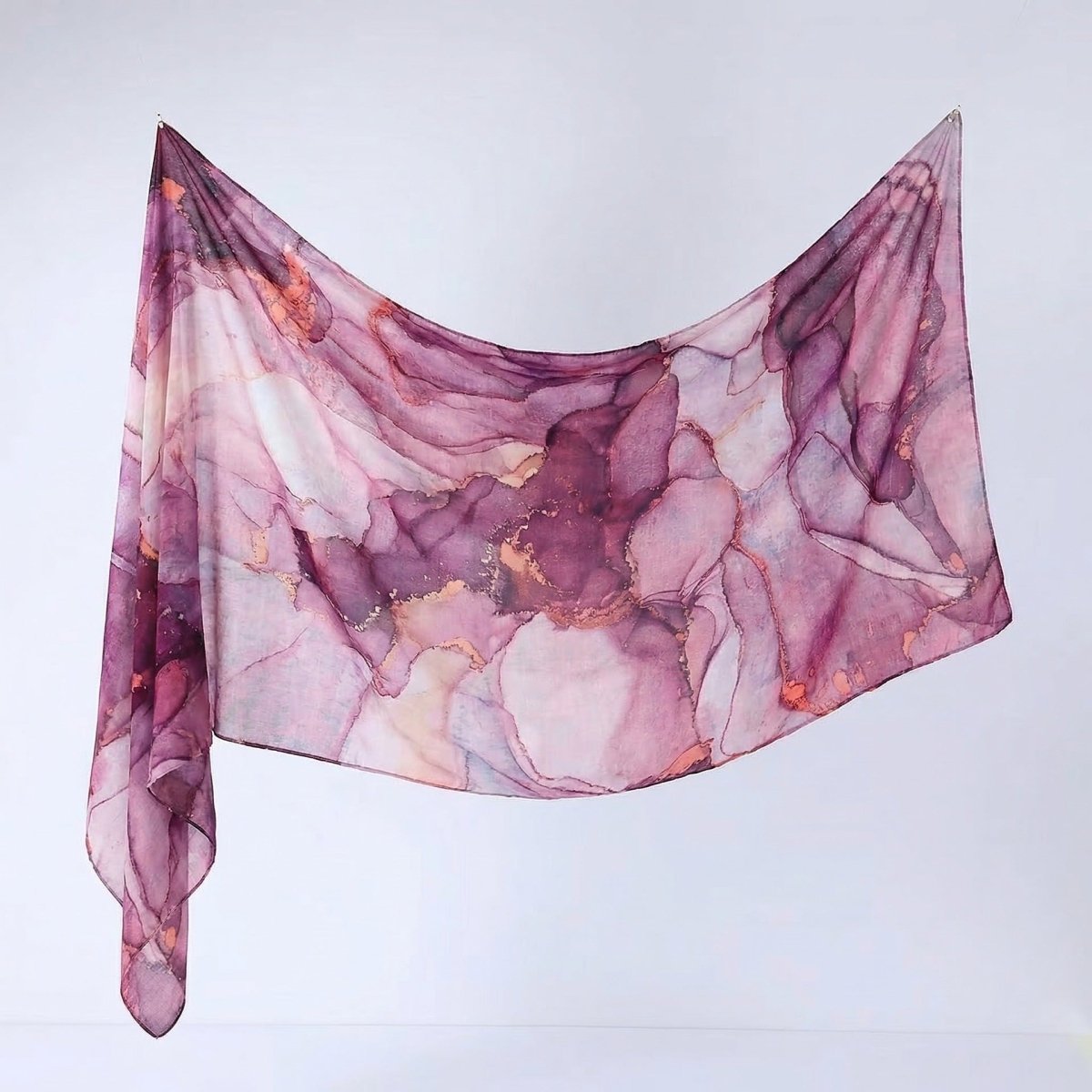 Close-up corner detail of ink-wash botanical printed hijab shawl