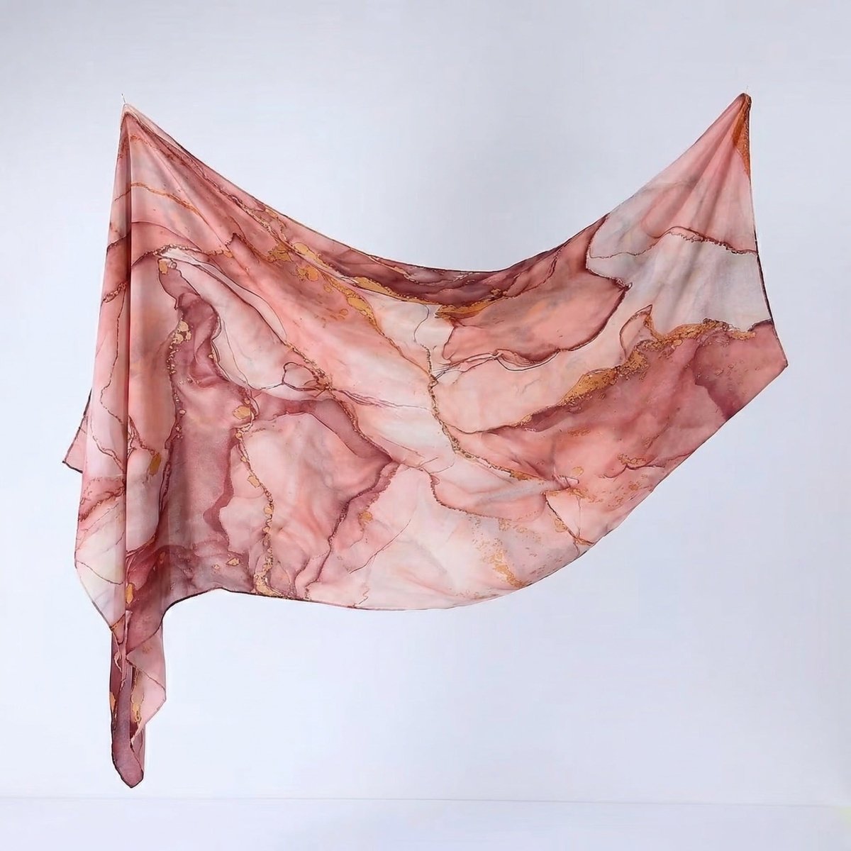 Editorial flat-lay of watercolour print hijab shawl showing full pattern