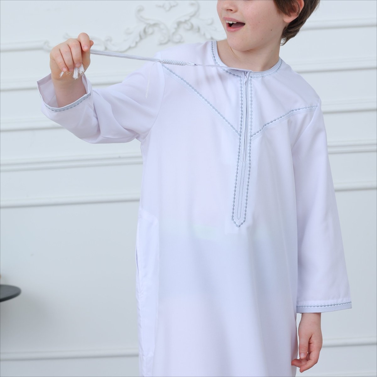 Full-length back view of white kaftan thobe with contrast stitching