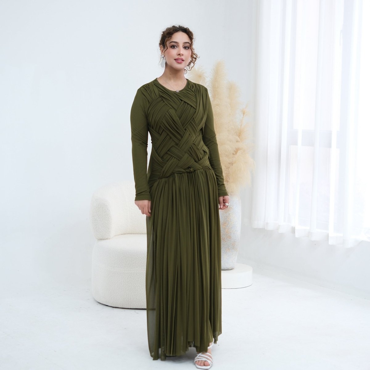 Full-length side view of fitted long sleeves and flowing mesh skirt